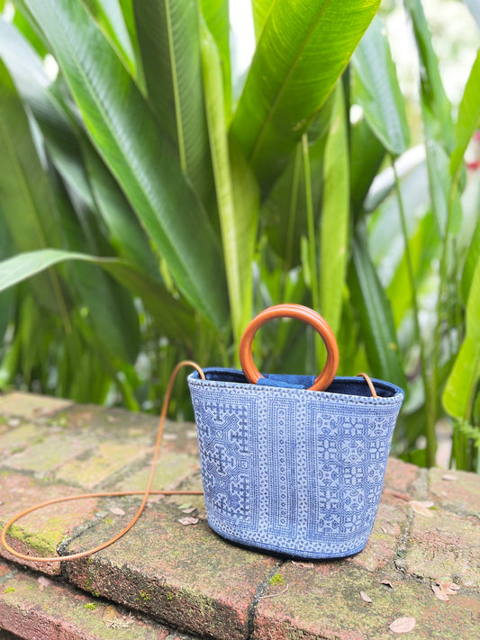 Handwoven vintage linen handle bag in Hmong indigo batik dyed art with solid wood handles. A rustic and ethnic plant dyed messenger bag.