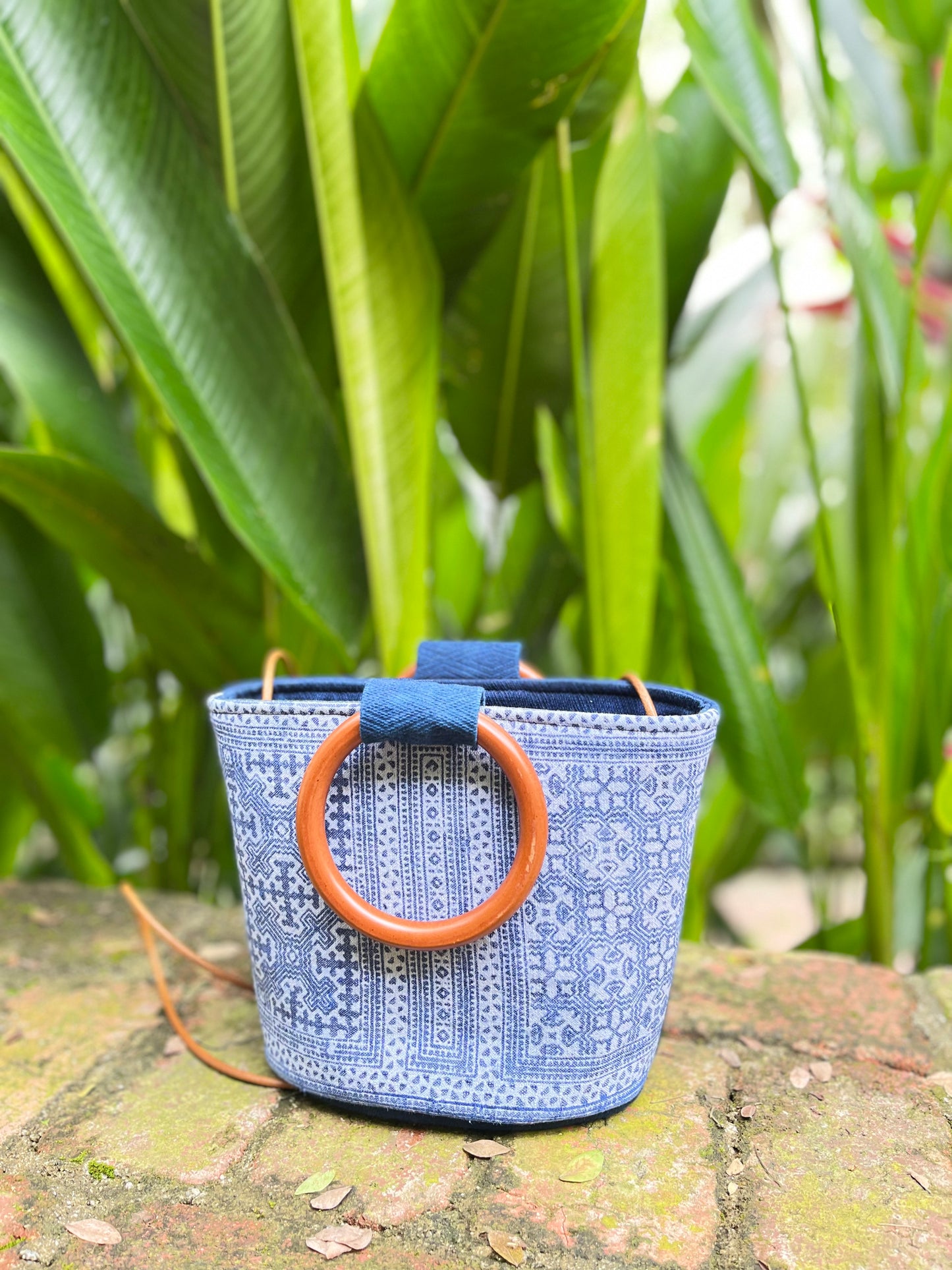 Handwoven vintage linen handle bag in Hmong indigo batik dyed art with solid wood handles. A rustic and ethnic plant dyed messenger bag.