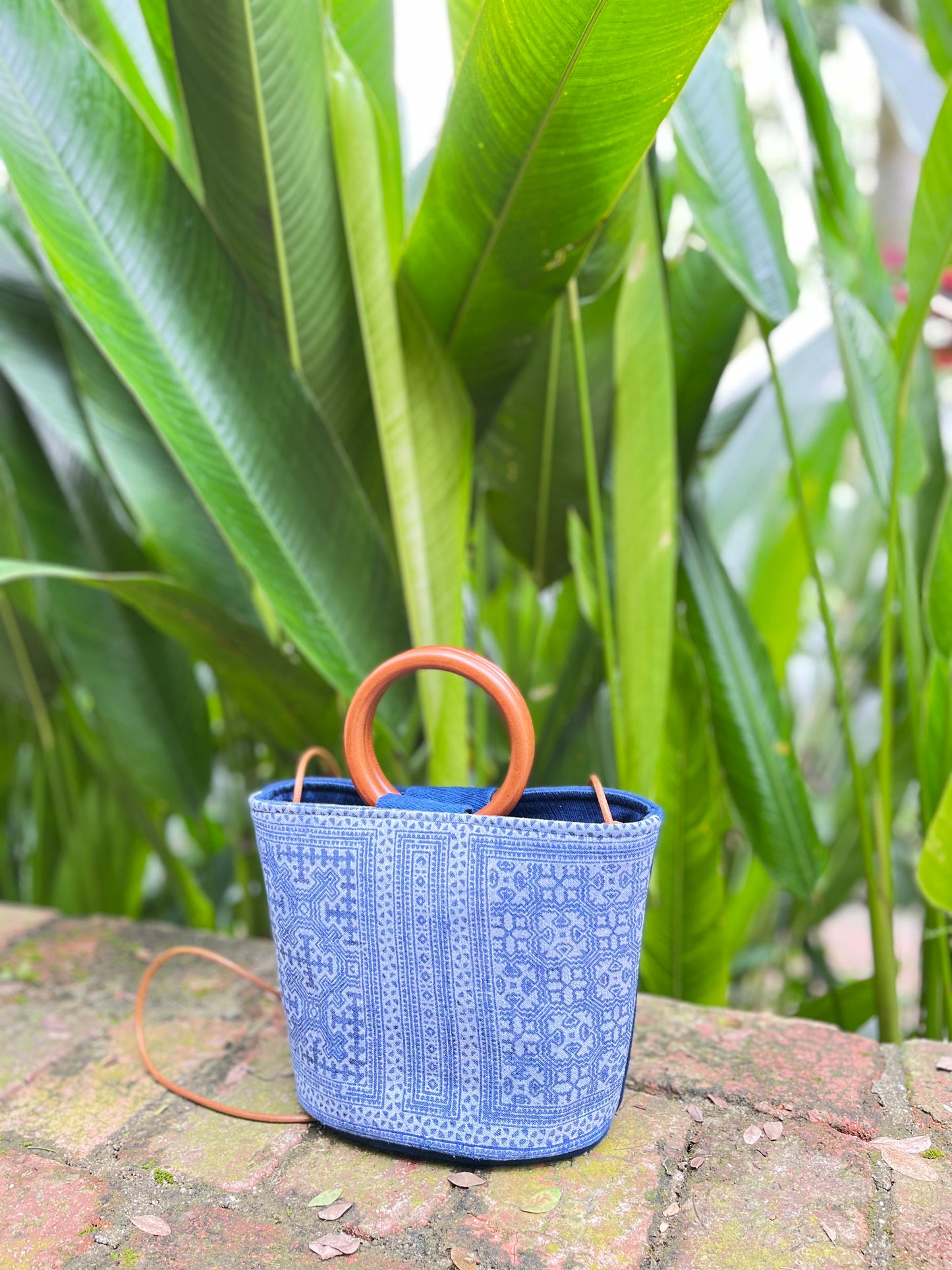 Handwoven vintage linen handle bag in Hmong indigo batik dyed art with solid wood handles. A rustic and ethnic plant dyed messenger bag.