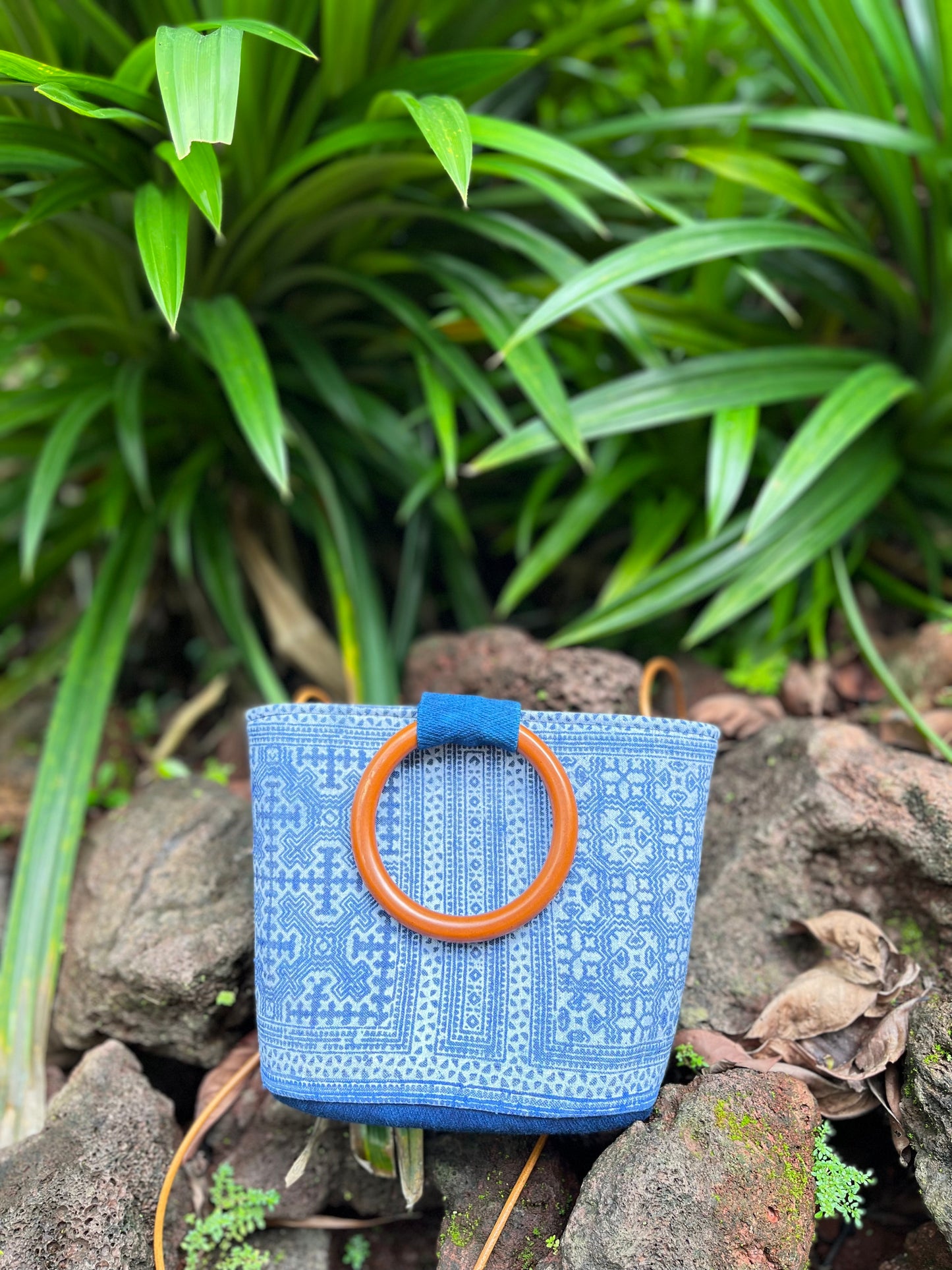 Handwoven vintage linen handle bag in Hmong indigo batik dyed art with solid wood handles. A rustic and ethnic plant dyed messenger bag.