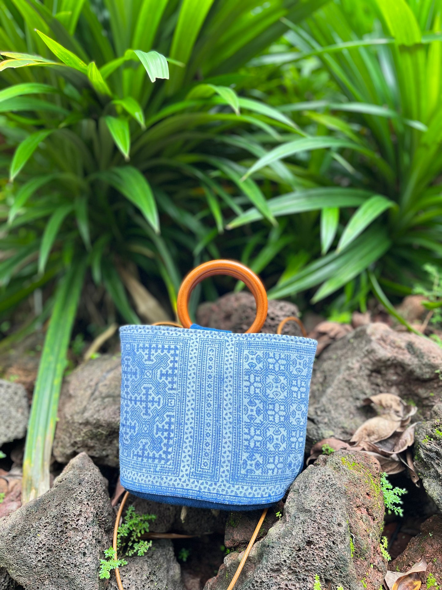 Handwoven vintage linen handle bag in Hmong indigo batik dyed art with solid wood handles. A rustic and ethnic plant dyed messenger bag.