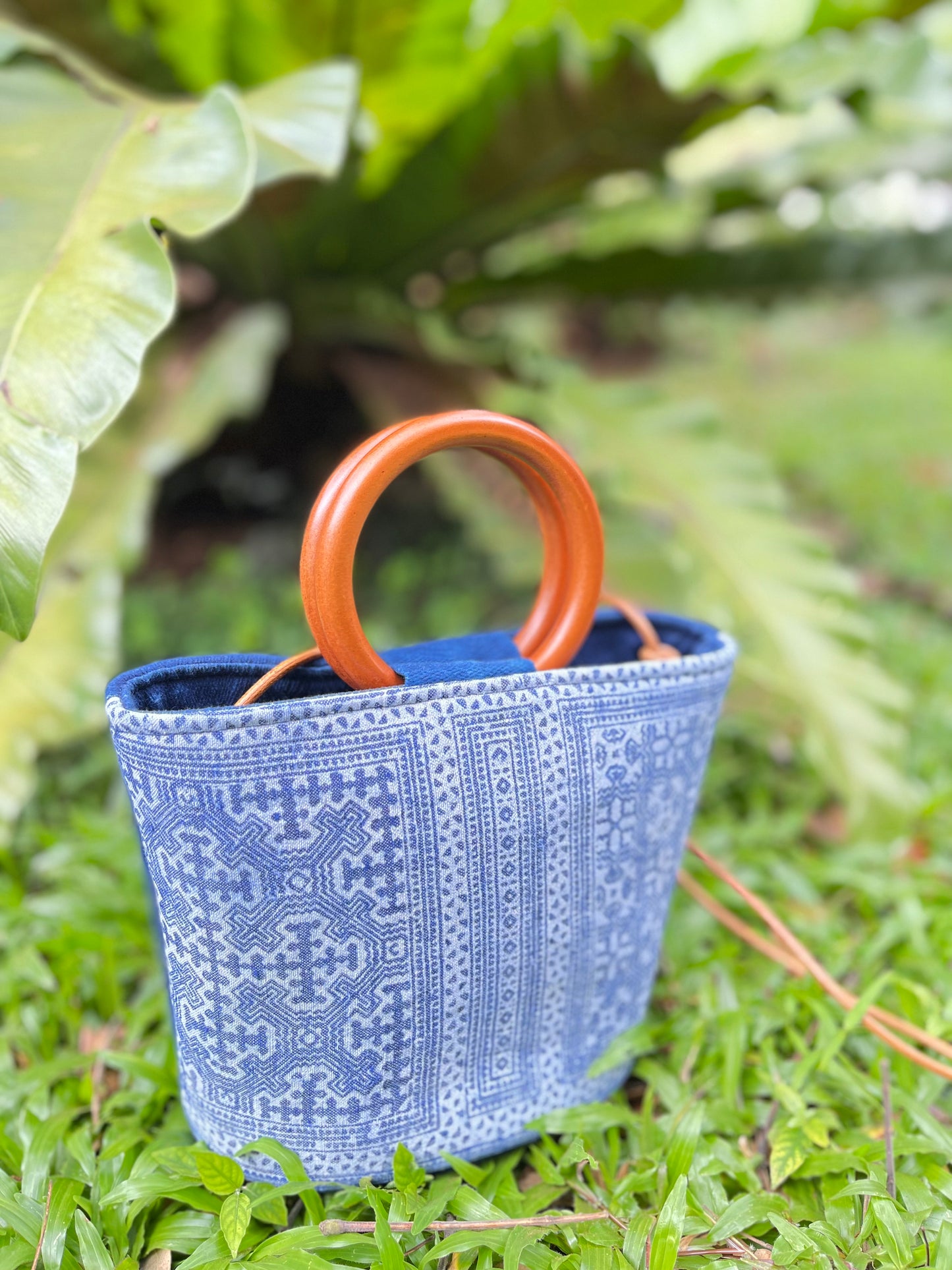 Handwoven vintage linen handle bag in Hmong indigo batik dyed art with solid wood handles. A rustic and ethnic plant dyed messenger bag.